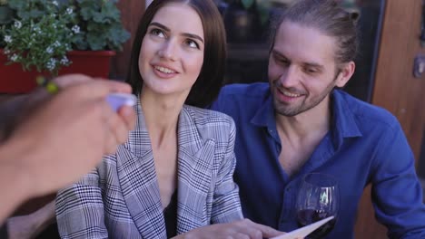 Couple-At-Restaurant.-People-With-Menu-Making-Order-At-Cafe