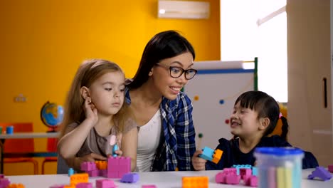 Schöne-verschiedene-Mädchen-genießen-Spielzeit-im-Klassenzimmer