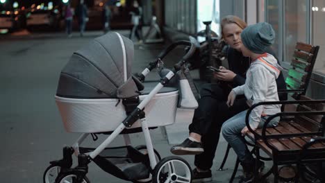 Woman-with-baby-and-elder-son-spending-evening-outside