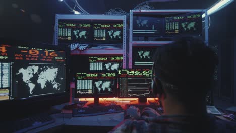 Hacker-using-computer-with-multiple-monitors