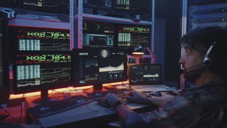 Hacker-using-computer-with-multiple-monitors