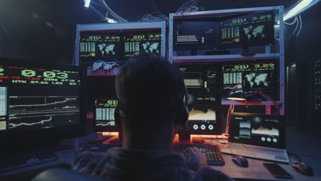 Hacker-using-computer-with-multiple-monitors