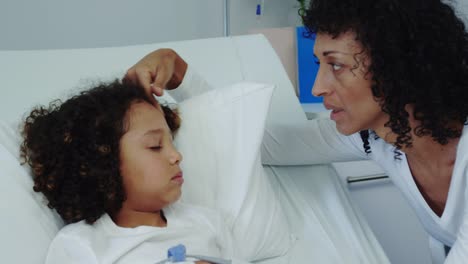 Front-view-of-African-american-mother-talking-with-her-son-in-ward-at-hospital-4k