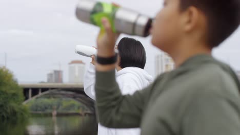 Asian-Mother-and-Son-Drinking-Water-after-Running