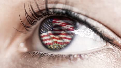 woman-green-eye-in-close-up-with-the-flag-of-USA-in-iris-with-wind-motion.-video-concept