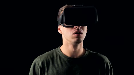 Portrait-of-Young-Man-using-VR-Glasses-on-Black-Background.-Male-Virtual-Reality-Console-Headset-Play-3D-Gaming-Innovation-Internet-Entertainment-Technology