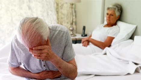 Upset-senior-couple-arguing-with-each-other-in-bedroom