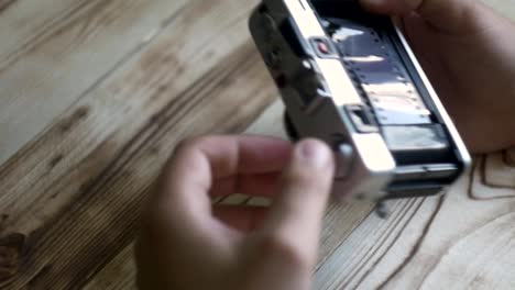 Closeup-of-male-hands-set-new-film.-vintage-camera.-rangefinder-camera