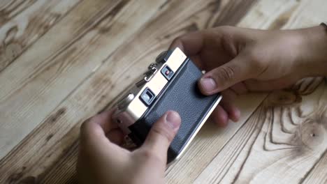 Closeup-of-male-hands-set-new-film.-vintage-camera.-rangefinder-camera