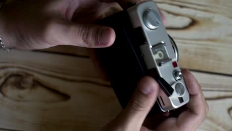 Closeup-of-male-hands-set-new-film.-vintage-camera.-rangefinder-camera