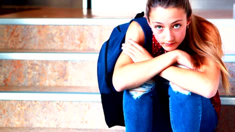 Sad-schoolgirl-sitting-alone-on-staircase