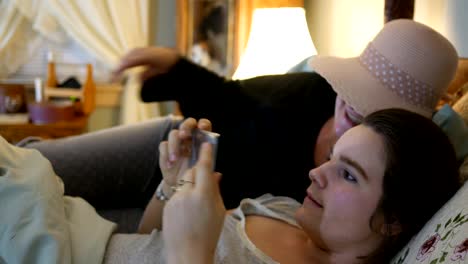 A-Mother-and-adult-daughter-taking-selfies-before-bed-with-smartphone