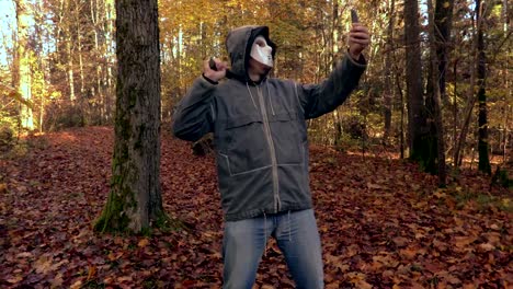 Man-with-scary-Halloween-mask-take-selfies-on-phone