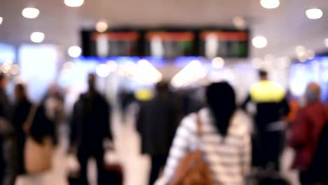 Defocused-traveler-and-crowded-people-walking-in-the-airport.