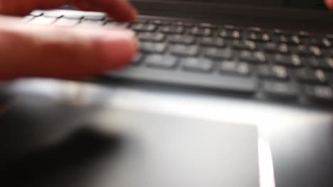 businessman-typing-on-a-laptop-keyboard-in-blurred-focus