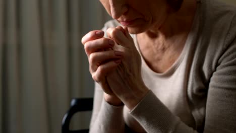 Old-woman-looking-at-her-wrinkled-hands,-realizing-her-weakness-and-helplessness