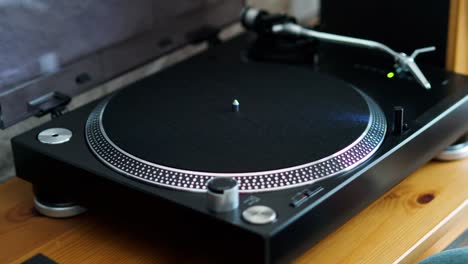 woman-turns-on-the-turntable-and-puts-the-LP