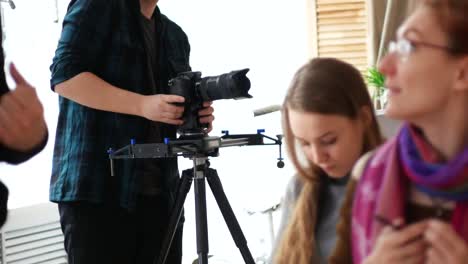 Videographer-shoots-at-the-camera-artists-in-the-studio