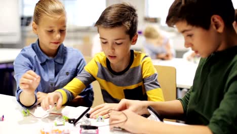 happy-children-at-robotics-school-making-high-five