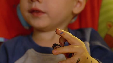 Video-Of-A-Young-Toddler-Boy-Making-A-Christmas-Wooden-Toy-Soldier-Craft-With-His-Mom-At-Their-Living-Room-Table