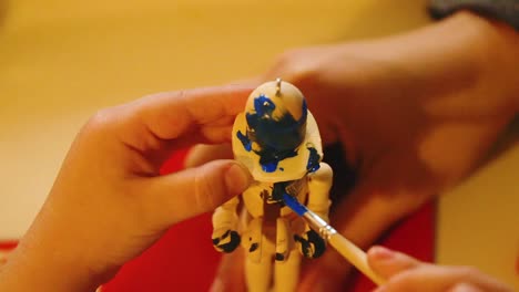 Video-Of-A-Young-Toddler-Boy-Making-A-Christmas-Wooden-Toy-Soldier-Craft-With-His-Mom-At-Their-Living-Room-Table