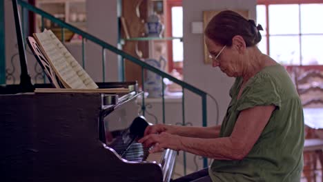 Old-woman-playing-a-grand-piano-at-her-home