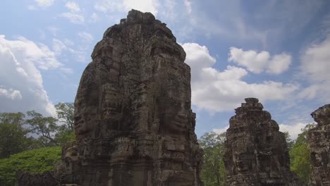 Spectacular-ancient-monuments-with-faces-on-each-side-fade-in-tropical-nature.