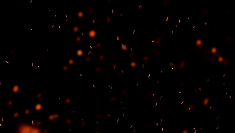 high-speed-shot-of-fire-flames-and-glowing-ash-particles-on-black-background