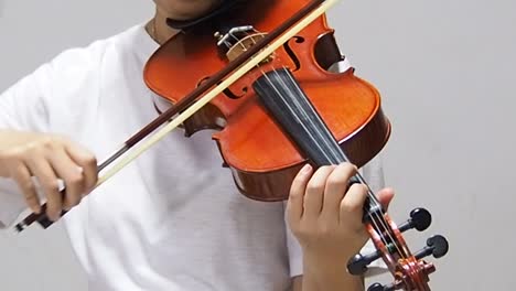 the-lady-is-using-bow-press-on-string-and-playing-song,