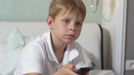 Little-Boy-Watching-TV-on-Bed