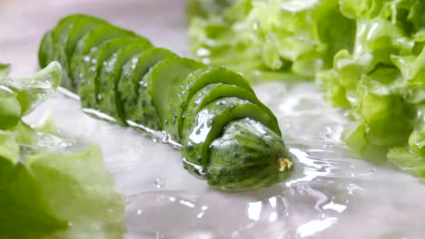 Falling-of-sliced-cucumber-into-the-wet-table.-Slow-motion-240-fps