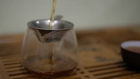 I-pour-tea-into-the-chahai-through-a-sieve.-Chinese-tea-ceremony.