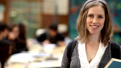 A-cute-female-college-student-looks-into-the-camera-and-smiles