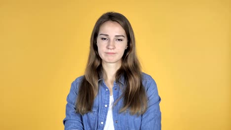 Pretty-Woman-Shaking-Head-to-Reject-Isolated-on-Yellow-Background