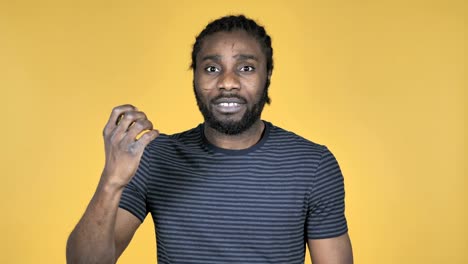 Fighting-Angry-Casual-African-Man-Isolated-on-Yellow-Background