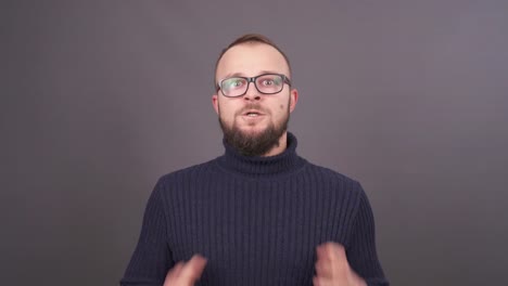 Portrait-of-a-bearded-young-angry-man-in-glasses.-He-is-screaming-and-mad-as-hell