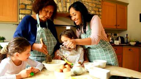 Siblings-preparing-food-with-family-in-kitchen-4k