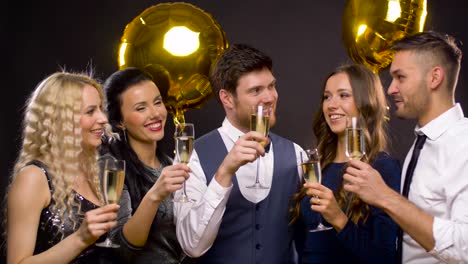 happy-friends-clinking-champagne-glasses-at-party