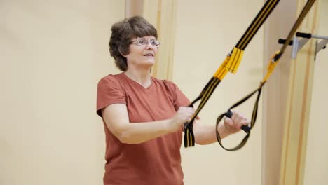 Senior-woman-doing-exercises-in-fitness-room.