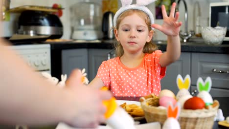 Girl-Watches-How-Mother-Decorating-Easter-Cookies