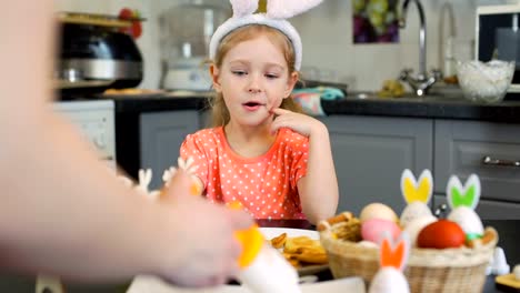 Little-Girl-Watches-How-Mother-Decorating-Cookies