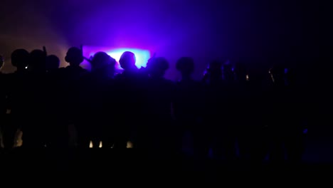 Anti-riot-police-give-signal-to-be-ready.-Government-power-concept.-Police-in-action.-Smoke-on-a-dark-background-with-lights.-Blue-red-flashing-sirens.-Dictatorship-power