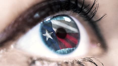 Woman-blue-eye-in-close-up-with-the-flag-of-Texas-state-in-iris,-united-states-of-america-with-wind-motion.-video-concept