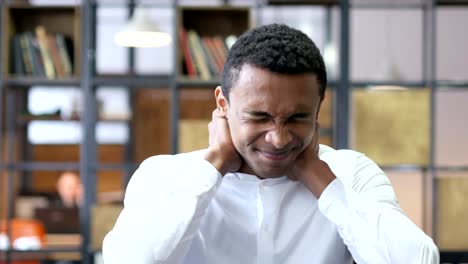 Tired-Black-Man-in-Office-with-Neck-Pain