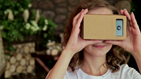 Young-curly-woman-using-Virtual-Reality-Glasses