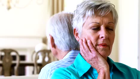 Upset-senior-couple-arguing-with-each-other-in-living-room