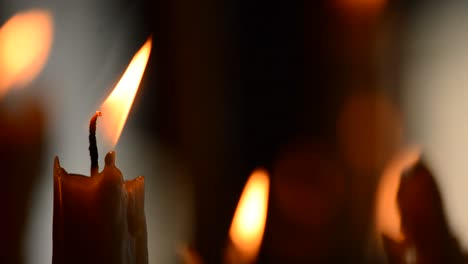 Candle-with-candles-defocused-in-background