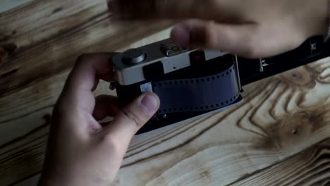 Closeup-of-male-hands-set-new-film.-vintage-camera.-rangefinder-camera