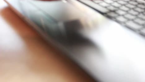 businessman-typing-on-a-laptop-keyboard-in-blurred-focus