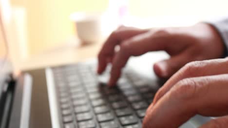 businessman-typing-on-a-laptop-keyboard-in-blurred-focus